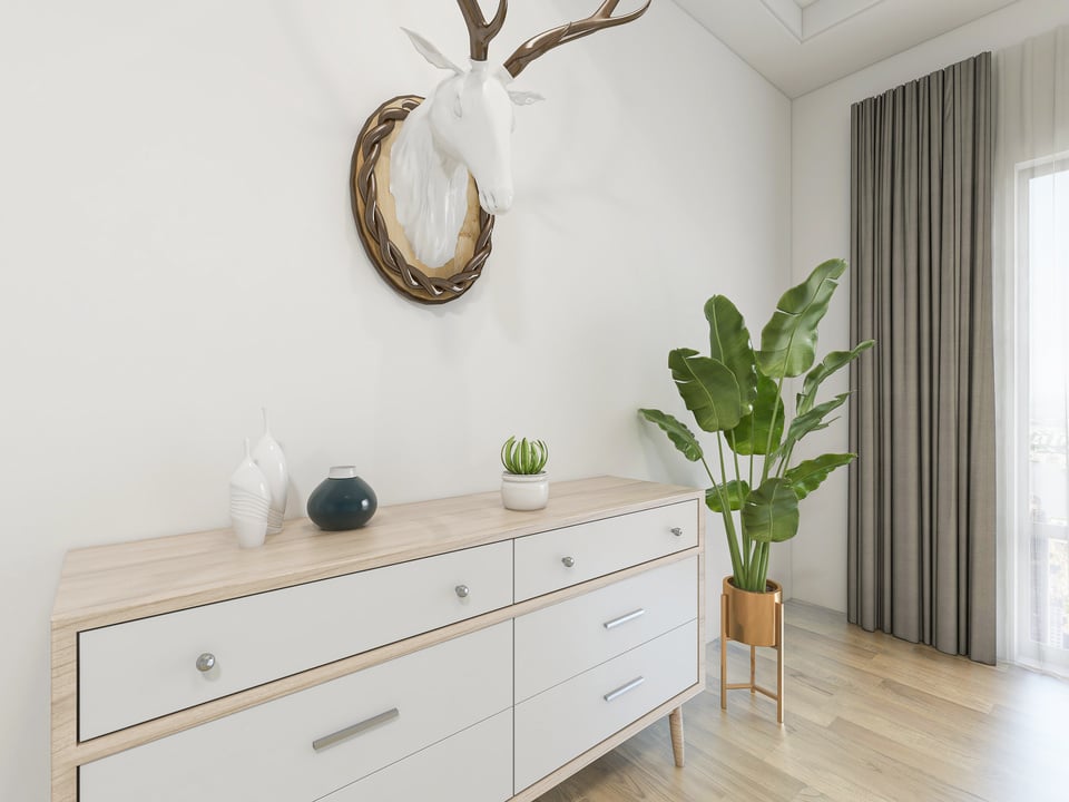 Modern design bedroom with large bed, chest of drawers, greenery